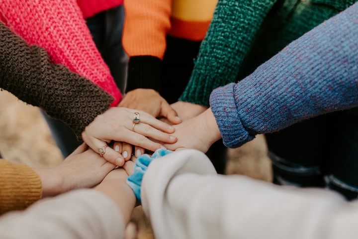 8 arms in a circle, with the hands all on top of each other in the center