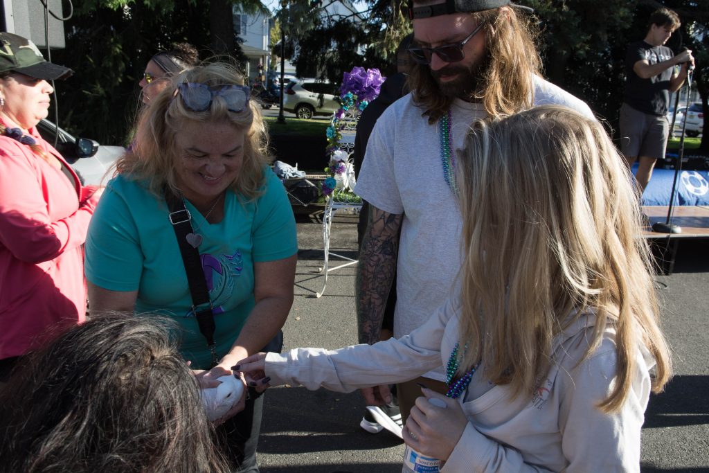 Dave and Cait looking at something another walk attendee is holding